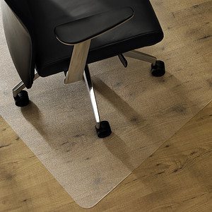 An APET chair mat with a chair on top resting on a hardwood floor