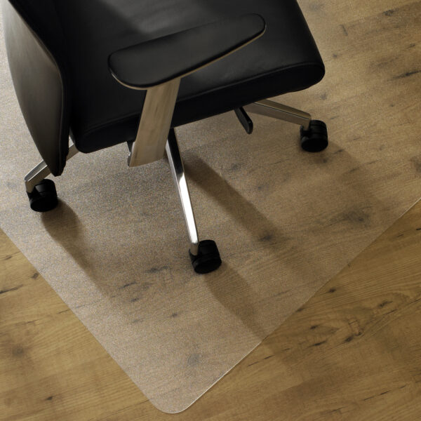 An APET chair mat with a chair on top resting on a hardwood floor